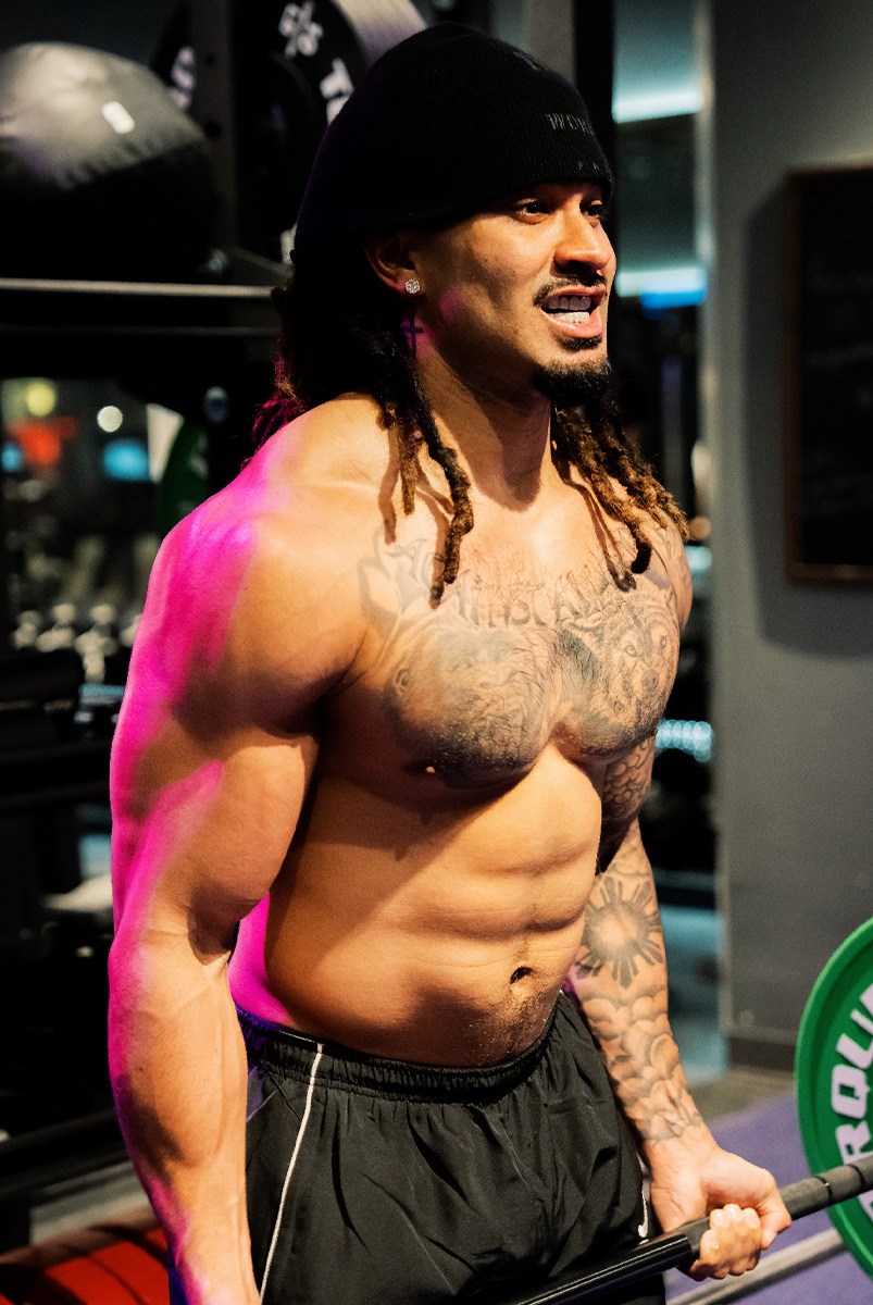 Coach lifting a barbell.